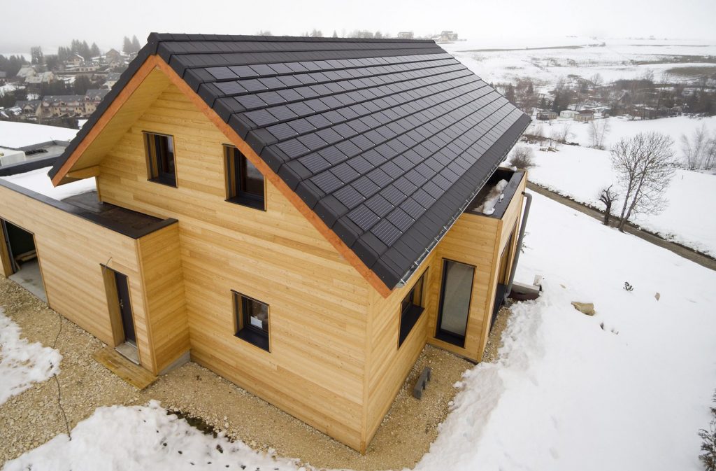 tuiles solaires sur une maison moderne en bois
